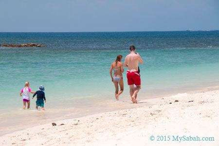 family walking on the beach