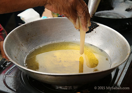 dropping flour into the hot oil