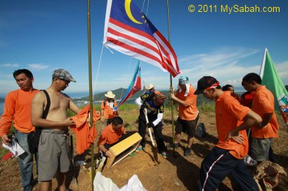 setting up flags and plaque on Gundul Hill