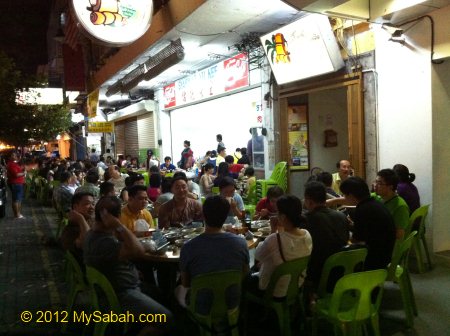 people sitting outside Yu Kee