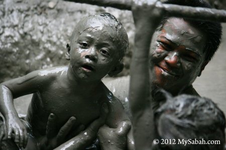 kid have fun in mud volcano