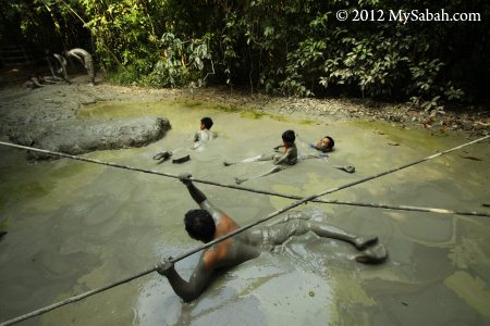 enjoying mud volcano bath in Pulau Tiga