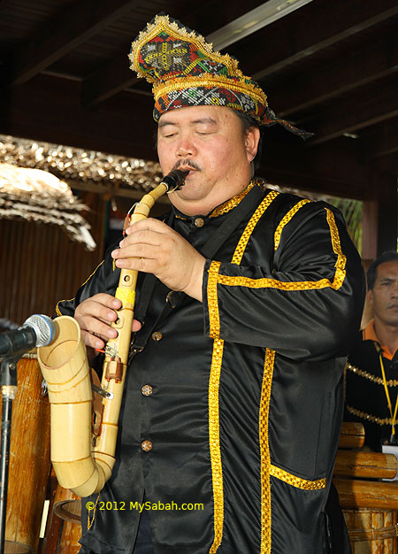 Kadazan man plays bamboo saxophone