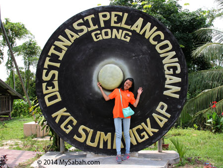 tourist taking picture with gong