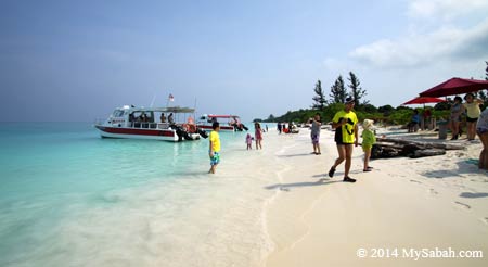 tourists at the seaside of Mengalum Island
