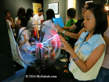 kid playing with Nebula globe