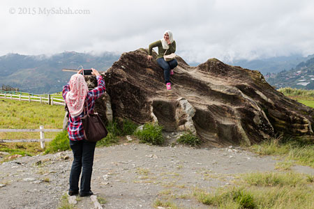 visitor taking photo on boulder