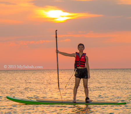 girl standing on Stand-up paddle-board