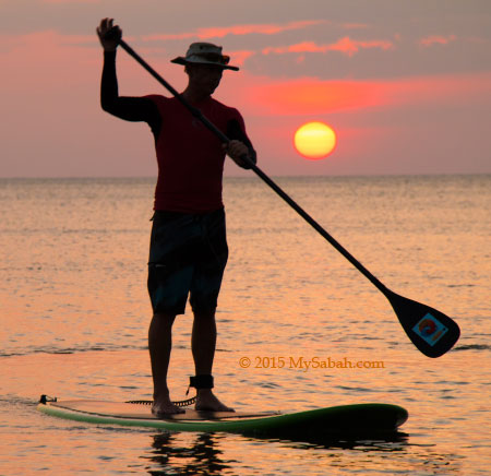 stand up paddle boarding during sunset