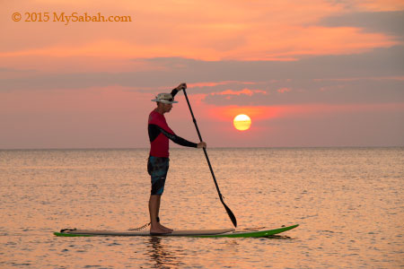 Standup paddleboarding in sunset