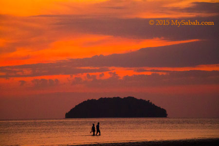 couples walking in sunset of Tanjung Aru Beach