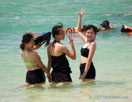 girls taking photo in water