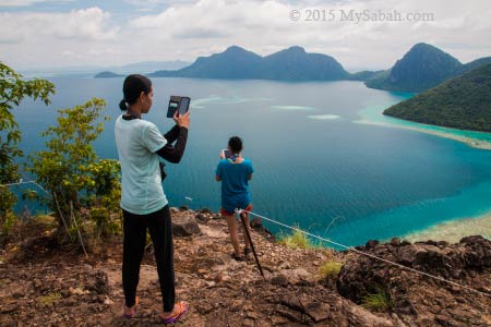 taking photo on peak of Bohey Dulang