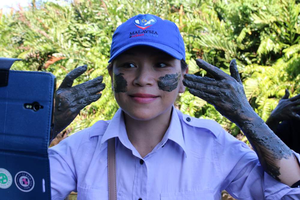 Applying volcano mud on face