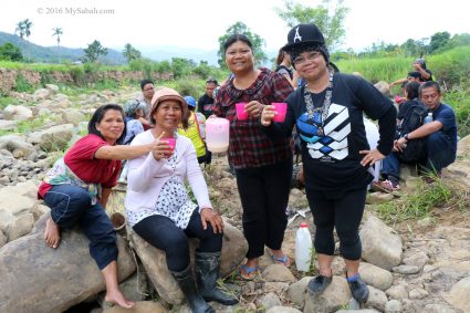 Enjoying drink with the villagers at the river side