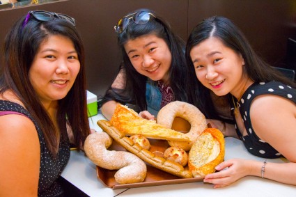 Girls taking photo with breads