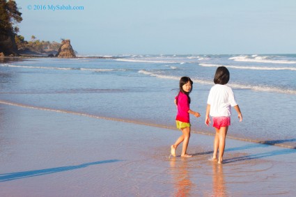 Children stroll on the beach