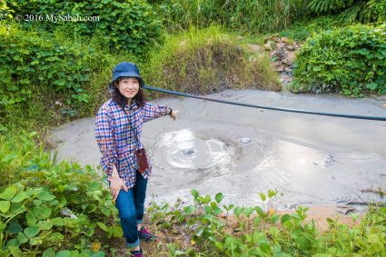 Girl pointing at mud volcano