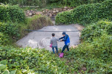 Collecting mud from mud volcano