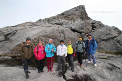 Group photo in front of Wishing Pond at the foot of Low's Peak