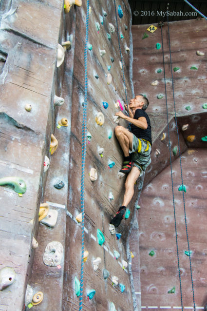 man trying wall climbing