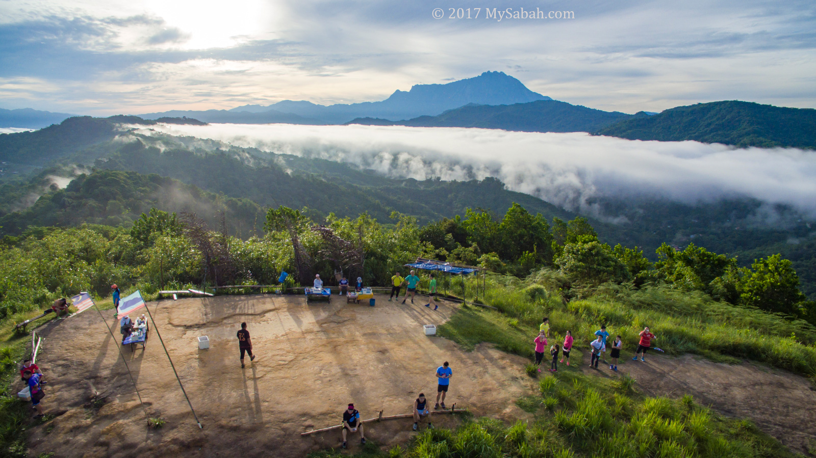 Hikers relax and enjoy the morning view on Bukit Perahu