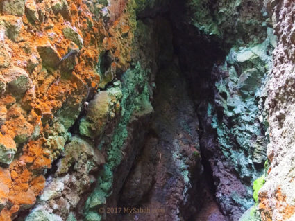 Colorized rocks in a small cave