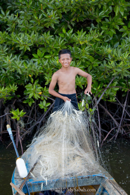 A young fisherman in Kampung Pansuran Village