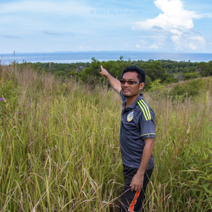 Moktar pointing at Kudat town