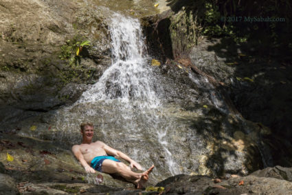 Tourist enjoys running stream of Ali Baba Waterfall