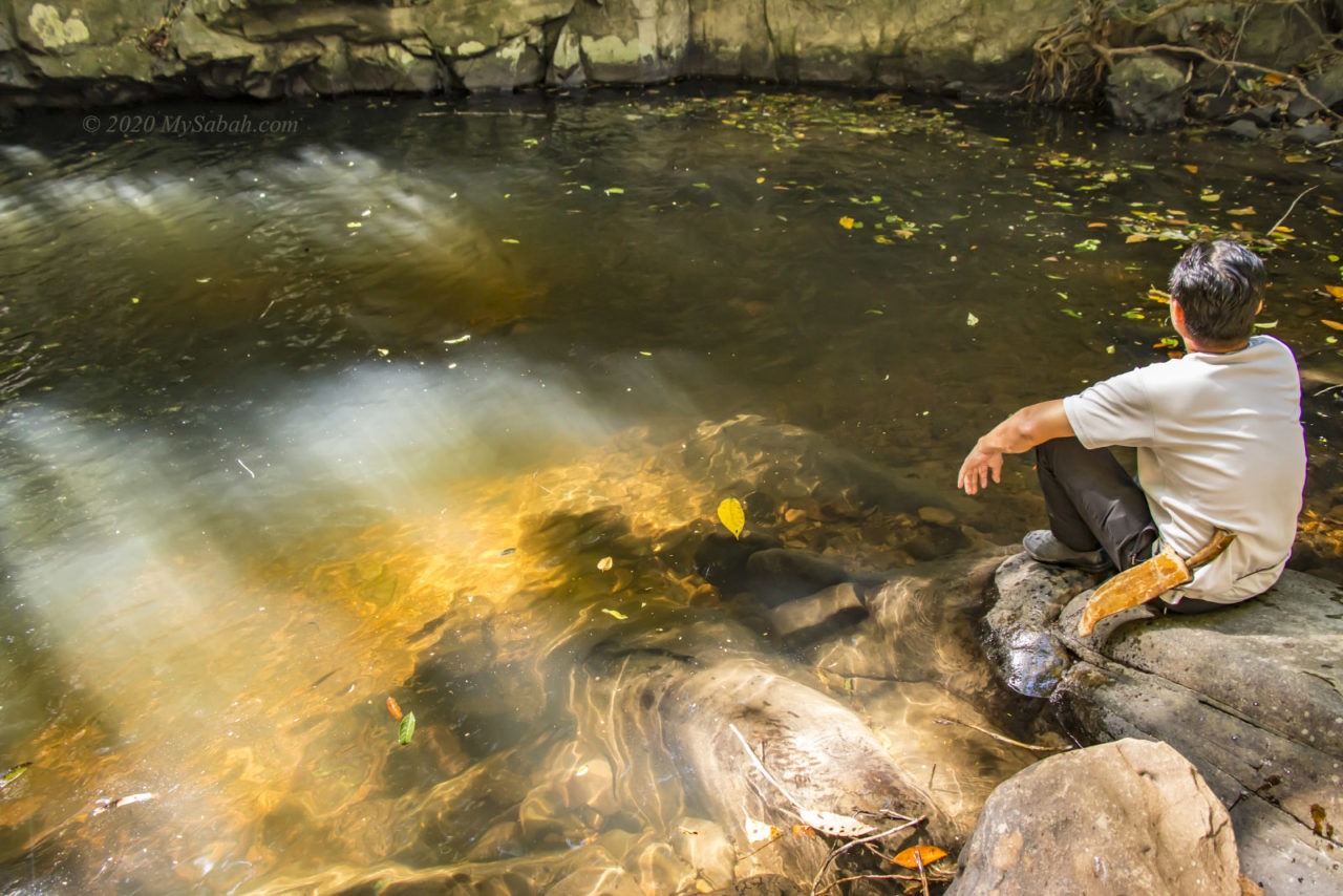 Morning sun-ray beams through the clear water of Wasai Waterfall