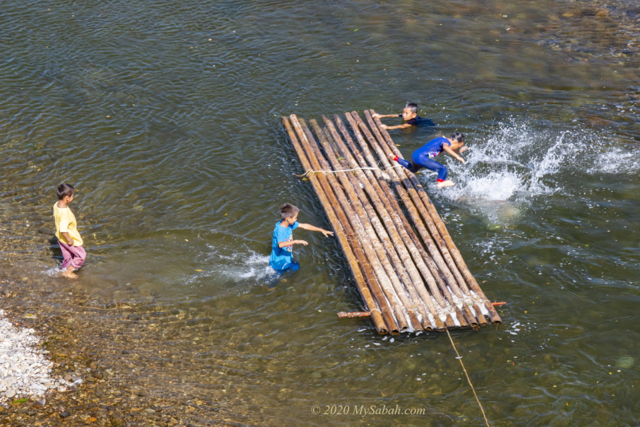 Children playing with bamboo raft