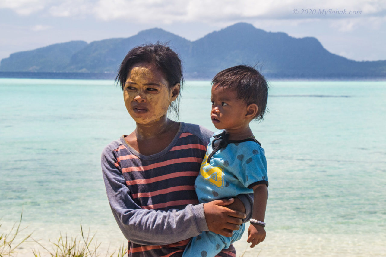 Sea Bajau girl holding a toddler