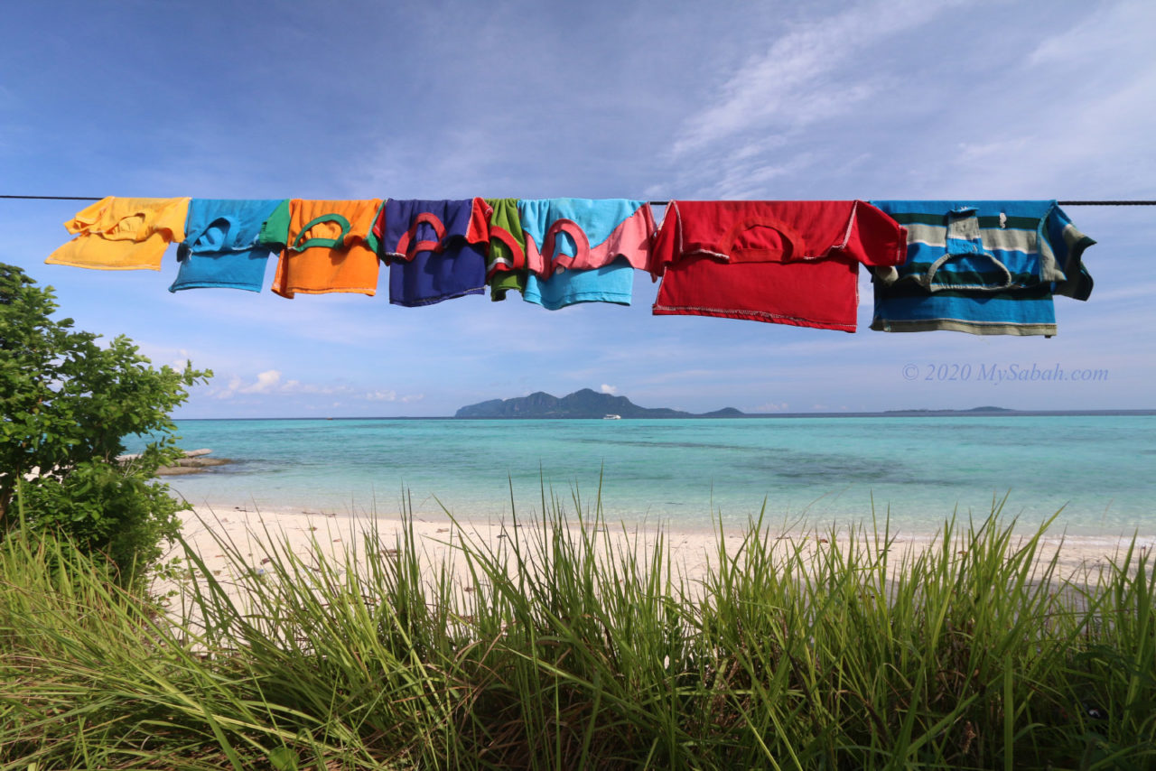 Hanging child clothing on the beach