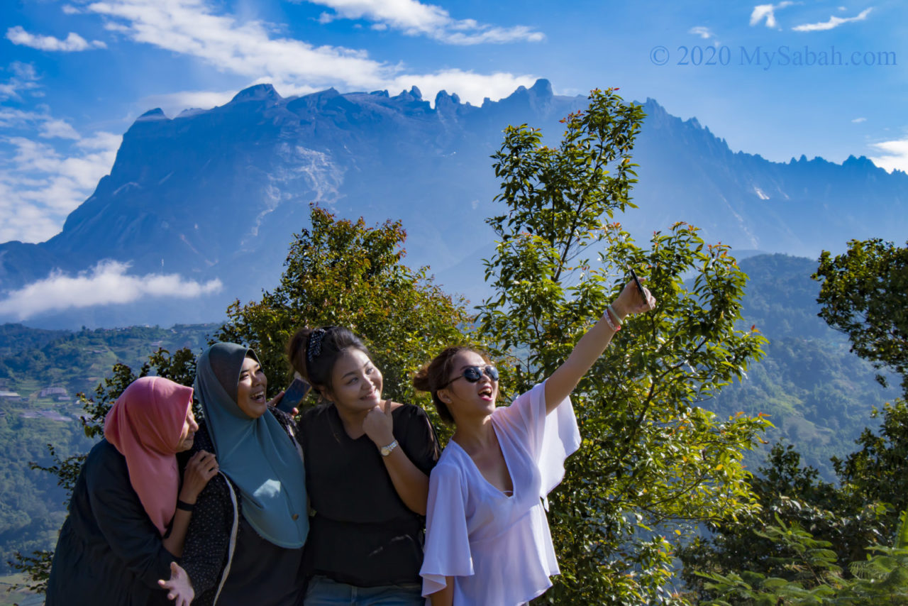 Girls selfie with Mount Kinabalu