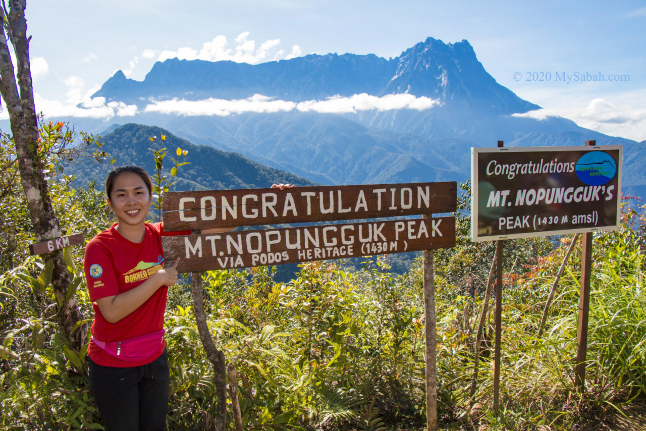 Photo next to summit signage of Mount Nopungguk