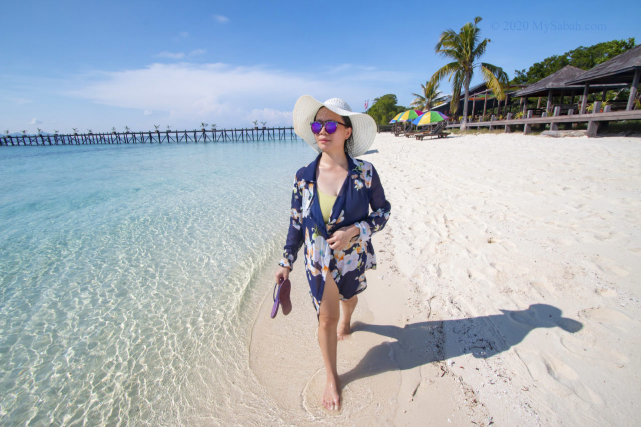 Lady walking on the beach of Pulau Timba-Timba