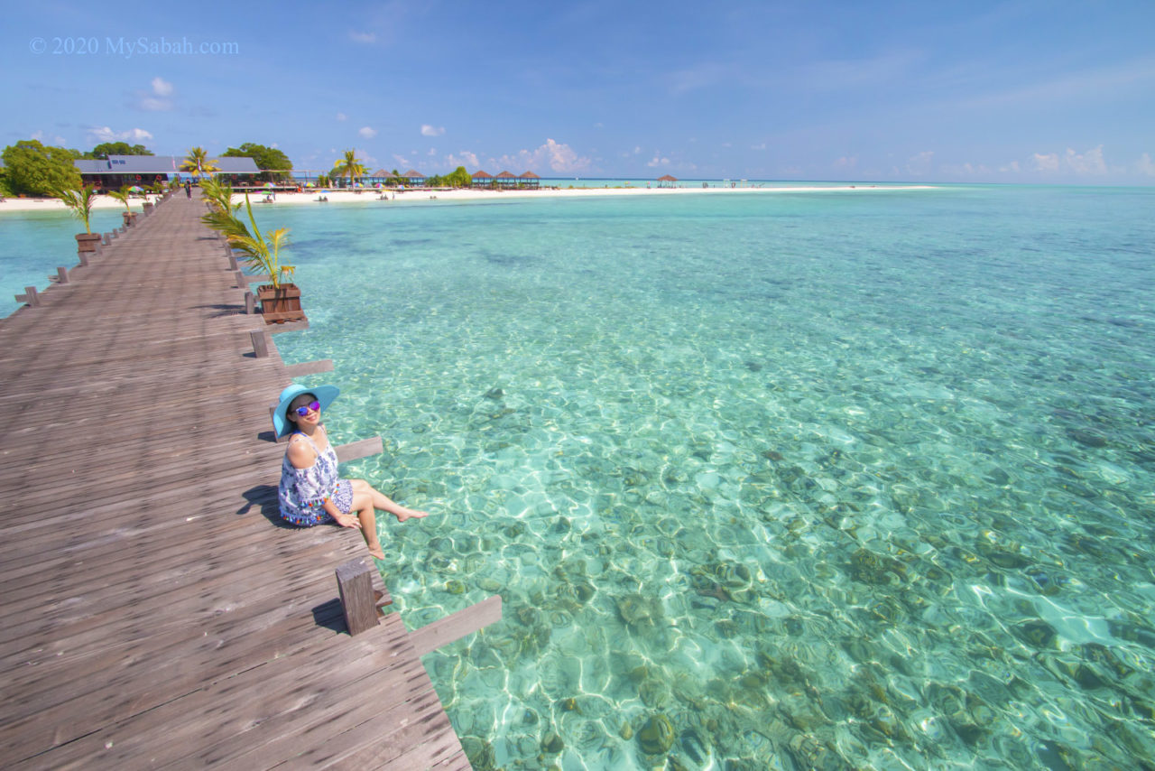 Girl sitting on the boardwalk of Timba-Timba Island