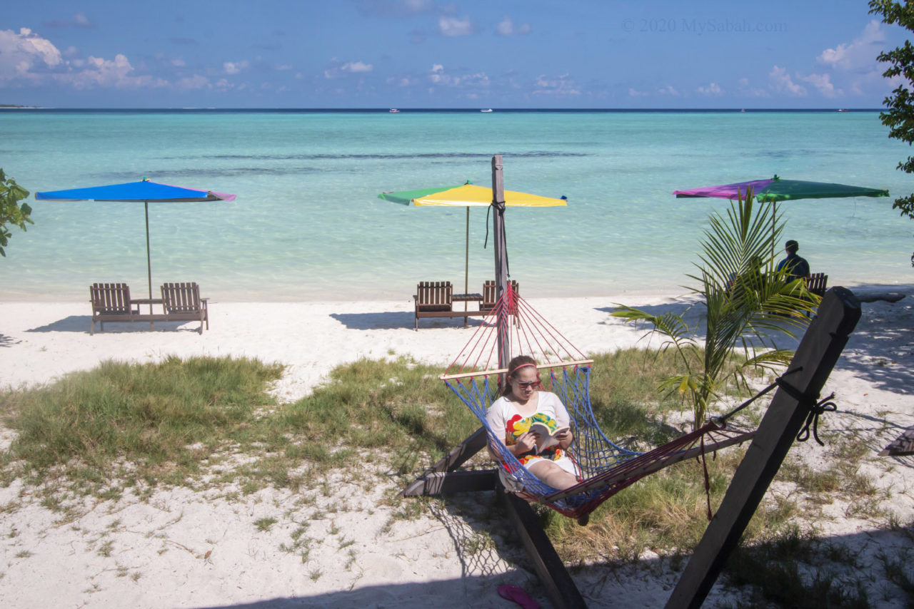 Reading book on the hammock of Timba-Timba Island