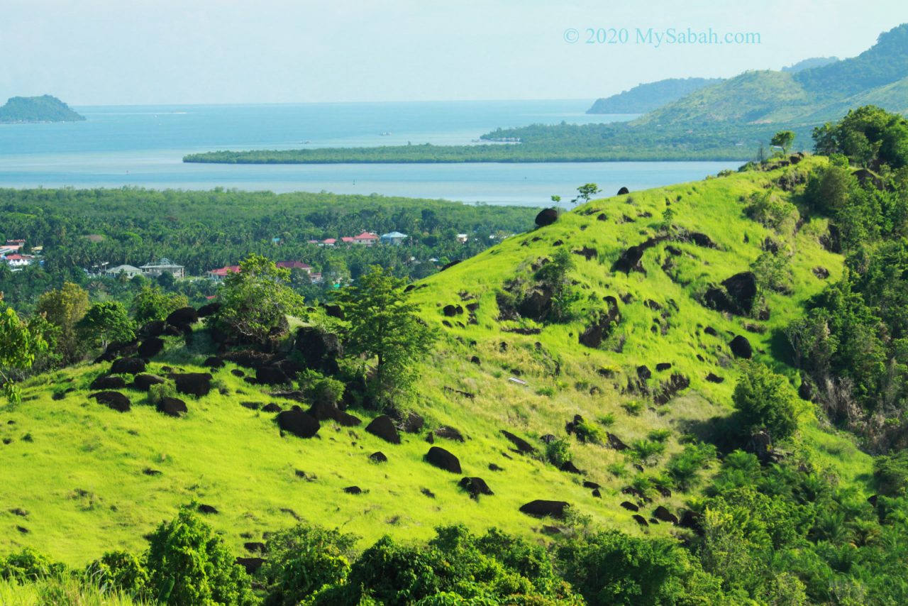 Black volcanic rocks on Bukit Tengkorak (Skull Hill)