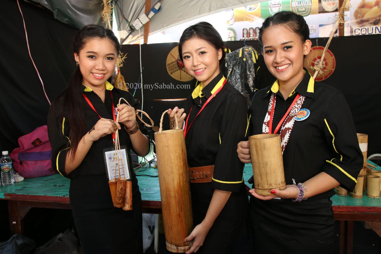 Girls holding bamboo cup (suki) for Sabah rice wine