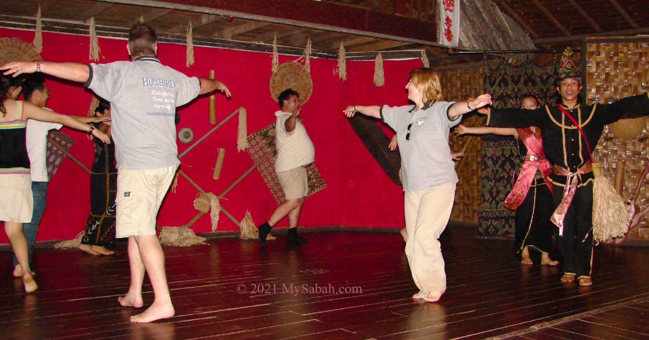 Tourists trying Sumazau dance in cultural village