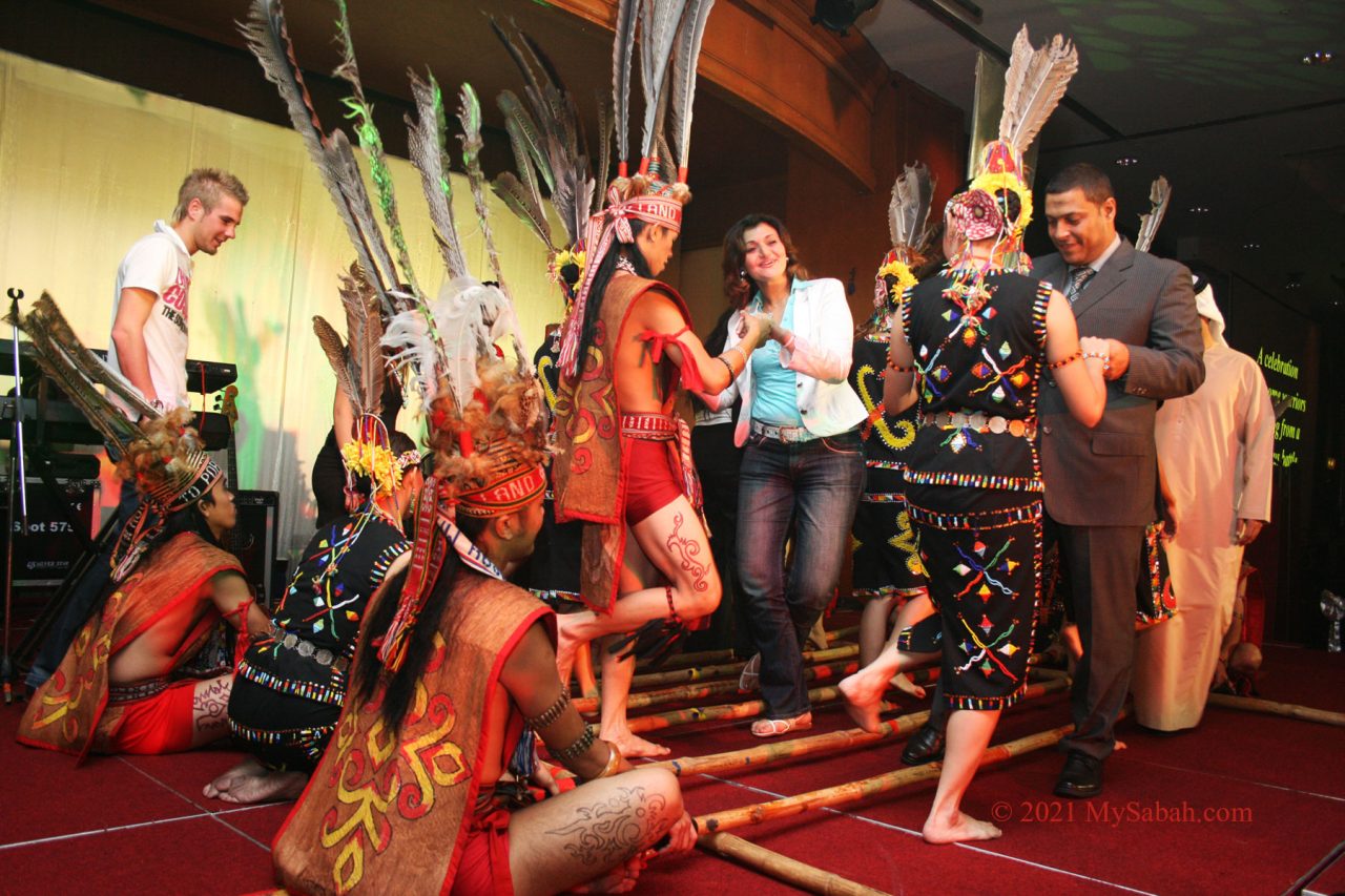 Tourists trying bamboo dance