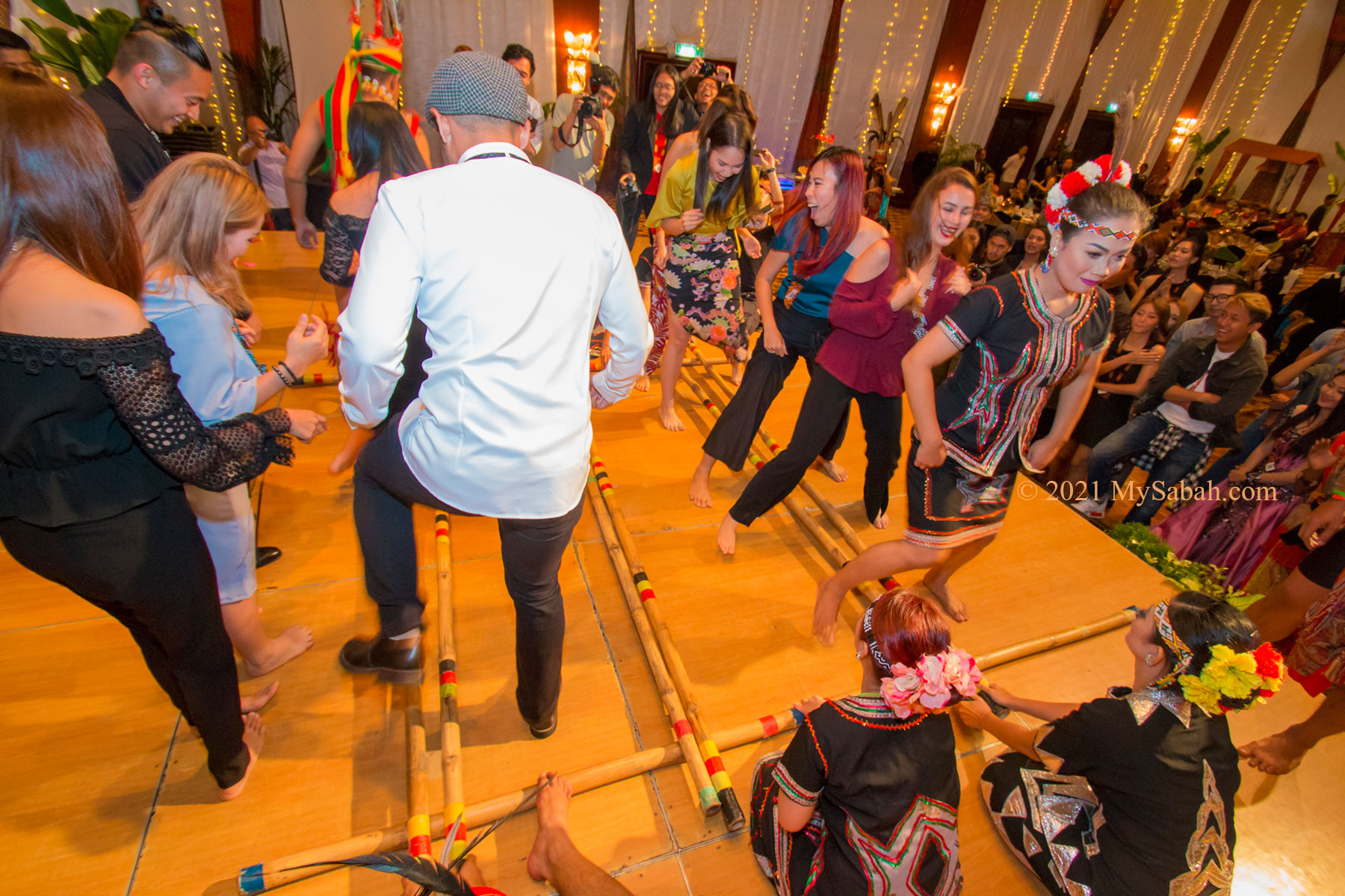 Tourists try Magunatip bamboo dance