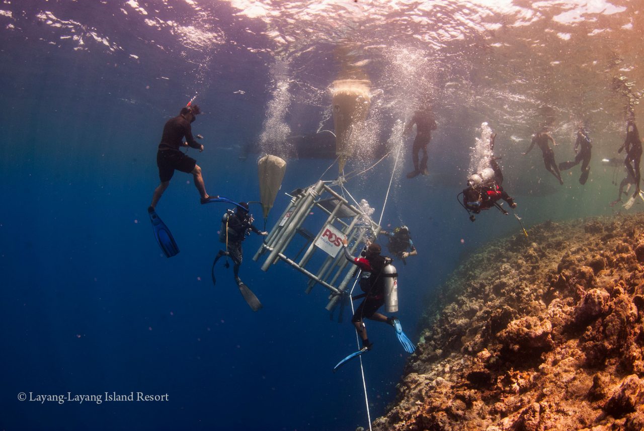 Divers installing the underwater post box for Layang-Layang