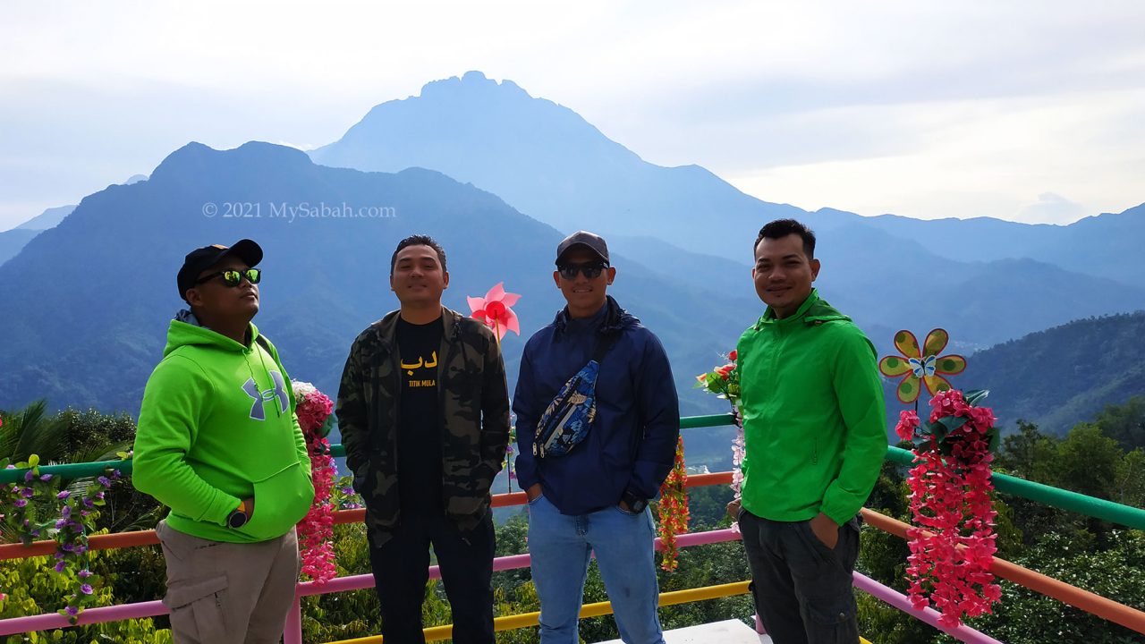 Tourists enjoy the twin mountains view on the platform