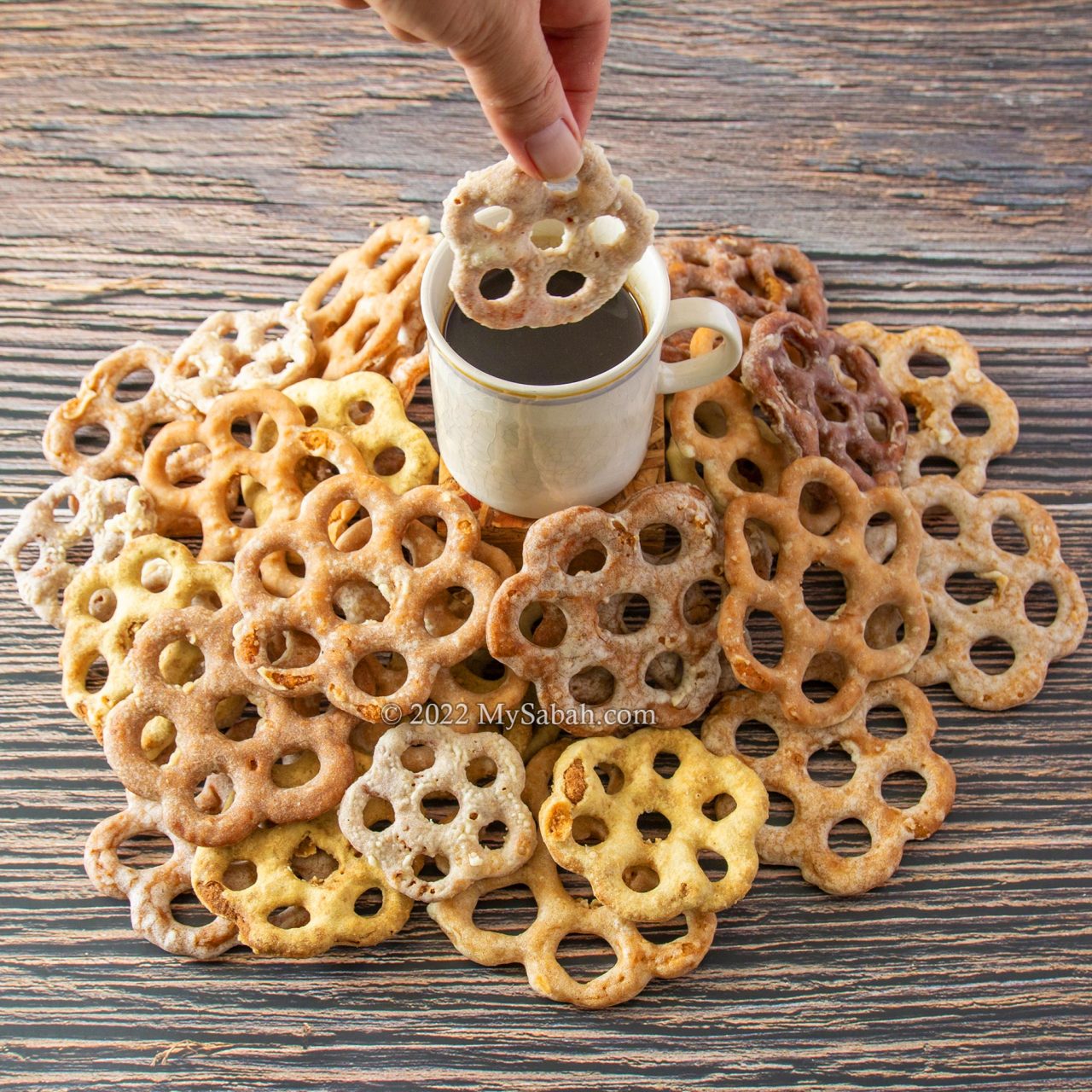 Dunking kuih cincin into coffee