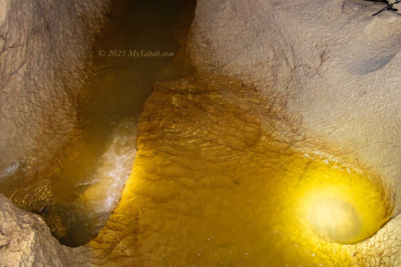 The running stream in the wet cave of Pungiton Cave