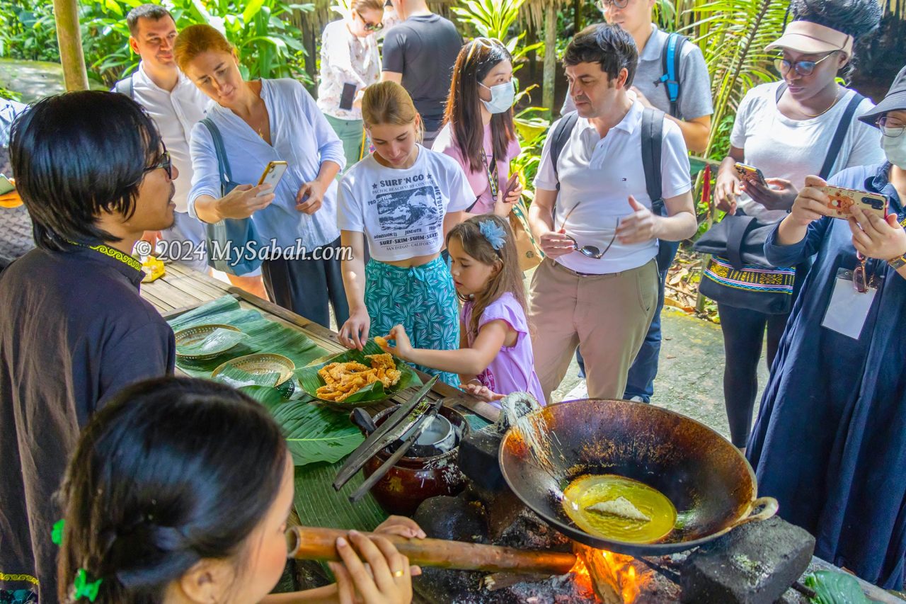 Sampling the freshly cooked local food (Kuih Jala)