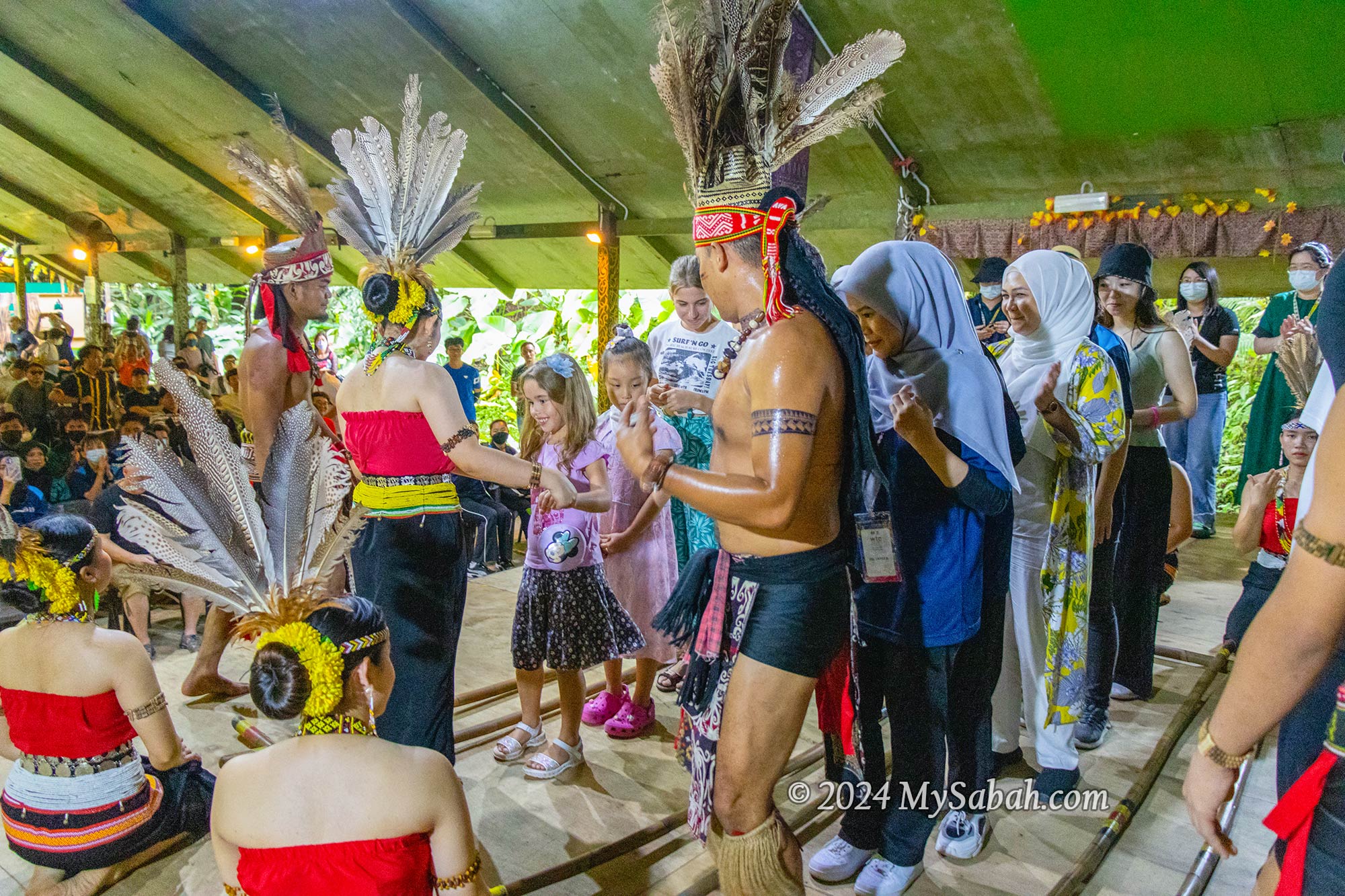 Tourists trying the bamboo dance